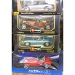 Four 1:18 scale model vehicles; two Burago, one Auto Art and one Maisto, Jaguar E Coupe 1961,