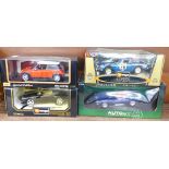 Four 1:18 scale model vehicles; two Burago, one Maisto and one Auto Art, Porsche 911,