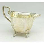 A silver cream jug,