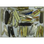A collection of fifty penknives, fruit knives and military issue,