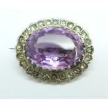 An amethyst and white stone brooch
