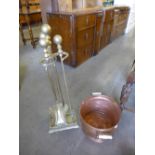 A brass companion set on stand and a copper log bucket