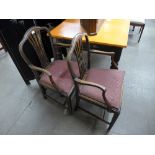 A pair of George III style mahogany elbow chairs