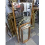 Three teak framed mirrors and another
