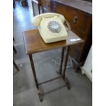 An oak occasional table and a vintage telephone