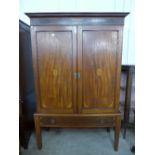 A George III style inlaid mahogany wardrobe