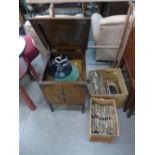 An oak cased gramophone with assorted records