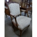 A French Louis XV style beech and upholstered fauteuil