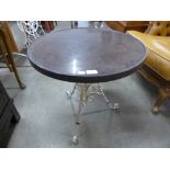 A wrought iron based occasional table