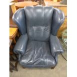A blue leather wingback armchair