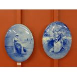 A pair of Royal Doulton blue and white oval plaques,