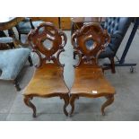 A pair of Victorian mahogany hall chairs