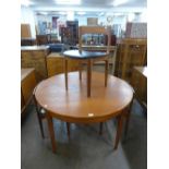 A teak extending dining table and four chairs