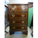 An inlaid mahogany chest of drawers