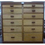 A light oak and teak collector's chest with twelve graduated drawers