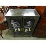 A Chinese lacquered side cabinet