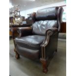 A chestnut leather reclining wingback armchair