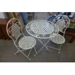A painted metal folding garden table and two chairs