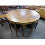 A teak extending dining table and four chairs