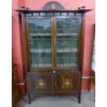 An Arts and Crafts inlaid mahogany bookcase