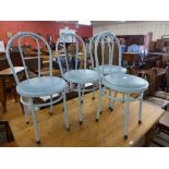 A set of four metal bistro chairs
