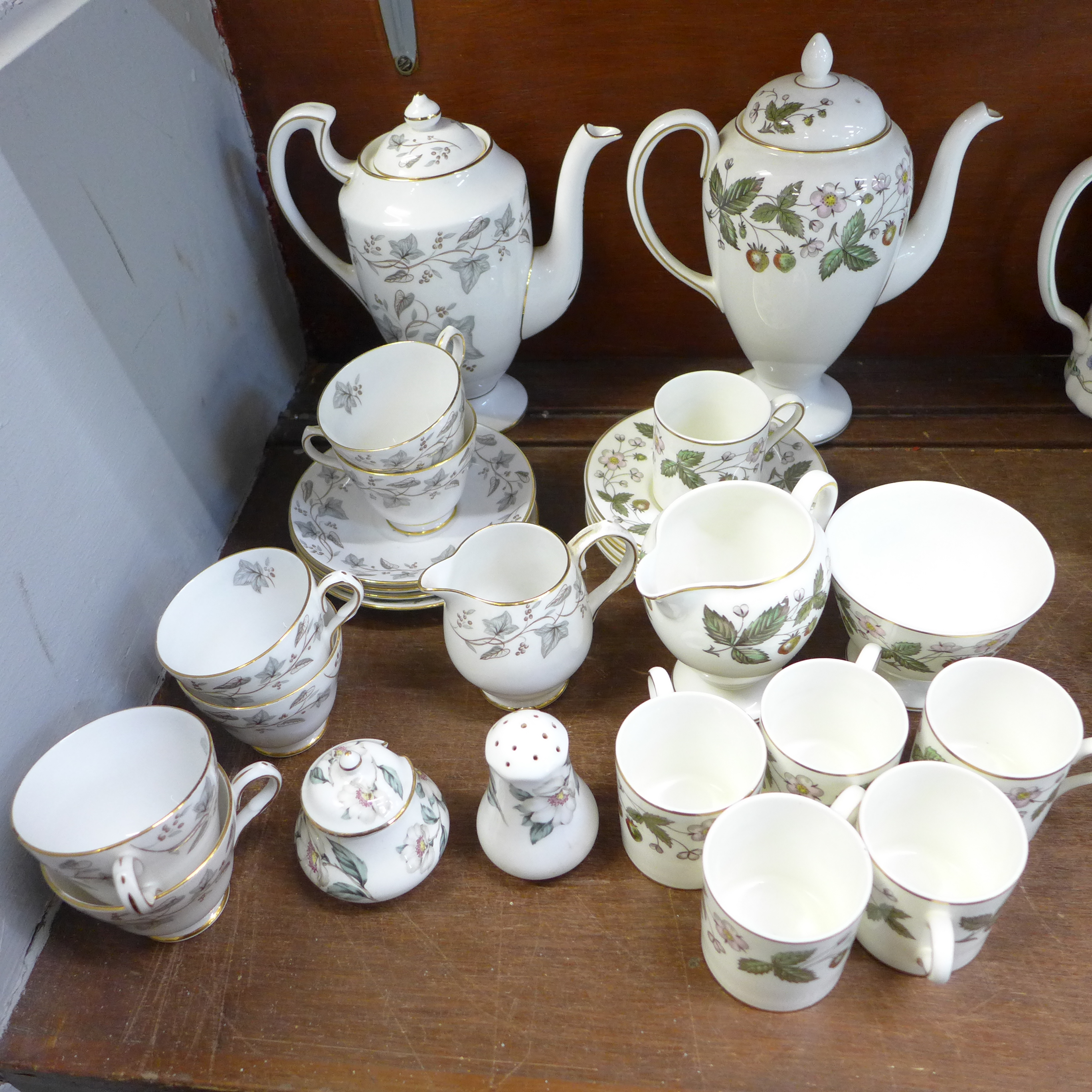 A Wedgwood Strawberry Hill six setting coffee set and a Grosvenor Crestwood six setting coffee set,