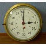 A military issue brass cased ship's clock, broad arrow mark to dial,