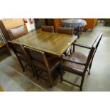 A carved oak draw-leaf refectory table and six dining chairs