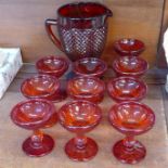 Ten pressed ruby glass goblets and a jug,