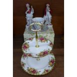 A Royal Albert Old Country Roses two-tier cake stand, a pair of continental figures,