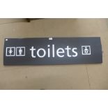 A metal Toilets sign