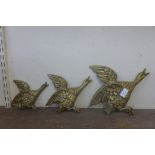 A set of three brass graduated flying ducks