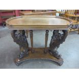 A Victorian oak silver or centre table, on heavily carved dolphin supports,
