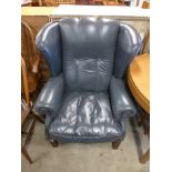 A blue leather wingback armchair