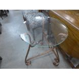 A wrought iron and glass topped occasional table