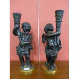 A pair of French bronze figural cherub candle stands