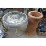 A terracotta chimney pot and a concrete bird bath