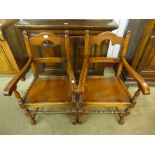 A pair of 17th Century style oak elbow chairs