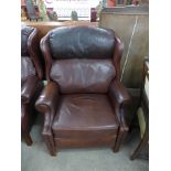 A brown leather reclining armchair