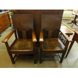 A pair of Arts and Crafts oak and leather armchairs