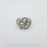 A 9ct gold and diamond set scroll ring, 3.