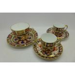 Three Royal Crown Derby cups and saucers;
