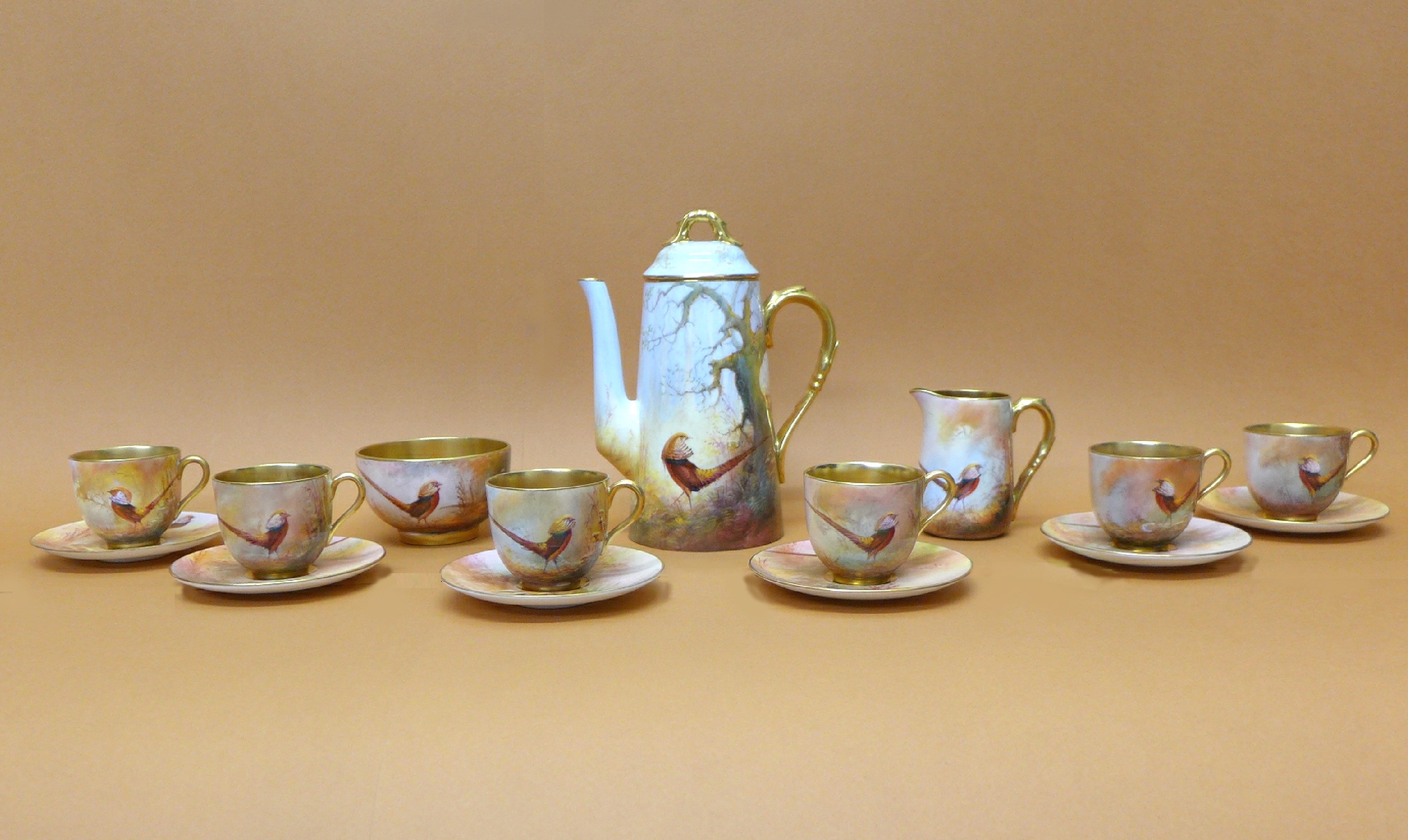 A Royal Worcester Walter Sedgley coffee set, six setting, with coffee pot, cream and sugar,