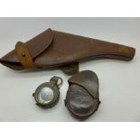 A leather pistol holster and a WWI Verner's Pattern VII compass with leather case (2)