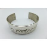 A hallmarked silver Yves Saint Laurent bangle,