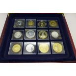 A collection of gold plated coins and other coins