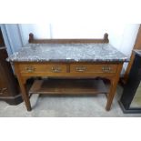 An Arts and Crafts oak and marble topped washstand