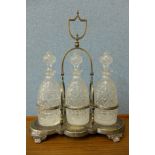 A Victorian silver plated tantalus with three cut glass decanters and other plated ware