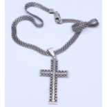 A silver cross and chain, 17.