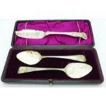 A pair of silver spoons, cased and a Victorian silver butter knife,